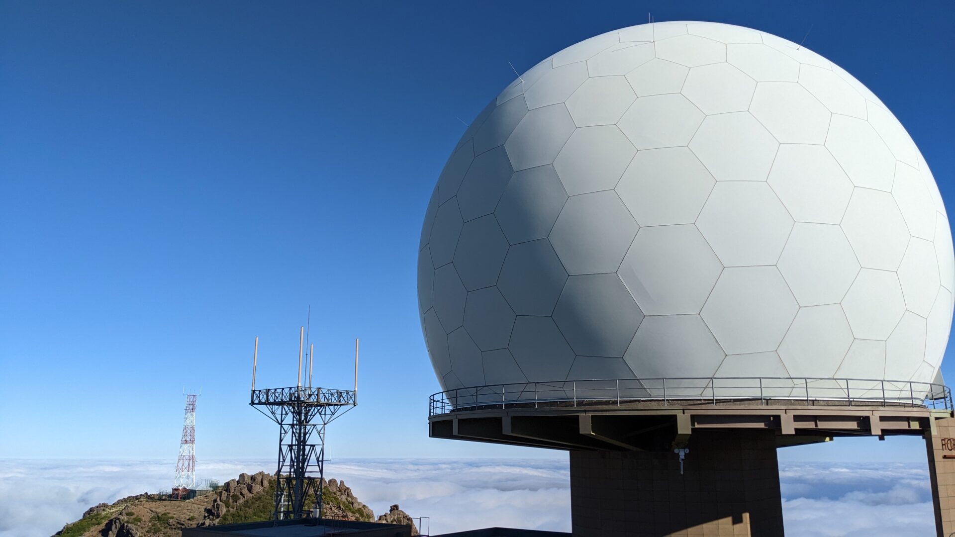Blue sky with radio towers and radar dome